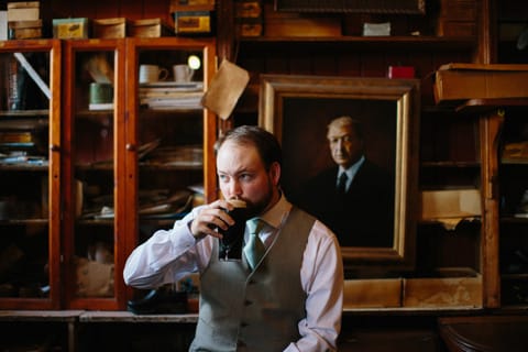 bridegroom drinking a pint of Guinness in dick macs pud dingle