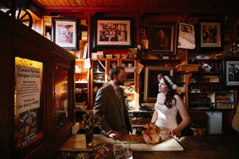 bridal couple in dick macs bar dingle with flowers