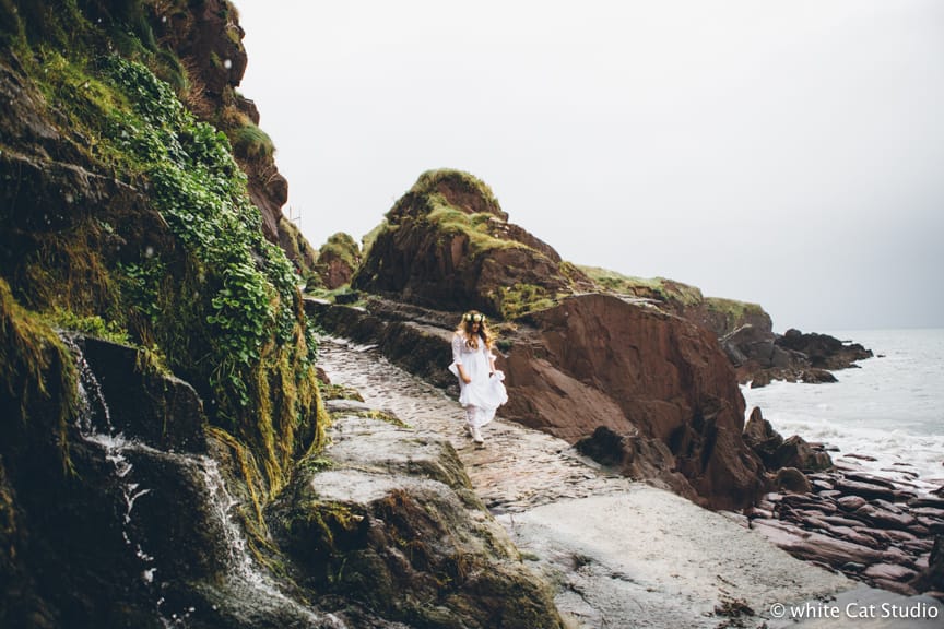 Winter Elopement in County Kerry, Ireland bride walking on the rocks 