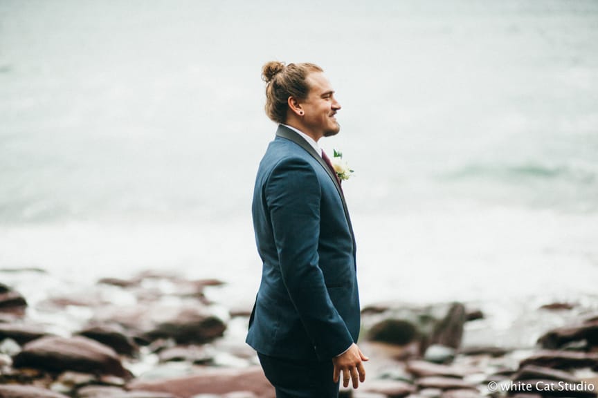 groom waiting on the rocks for his bride for theri Winter Elopement in County Kerry, Ireland