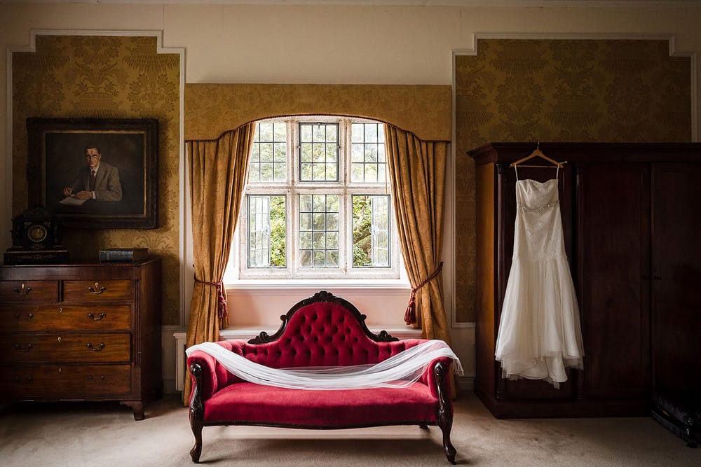 Castle elopement wedding dress on the red chaise lounge