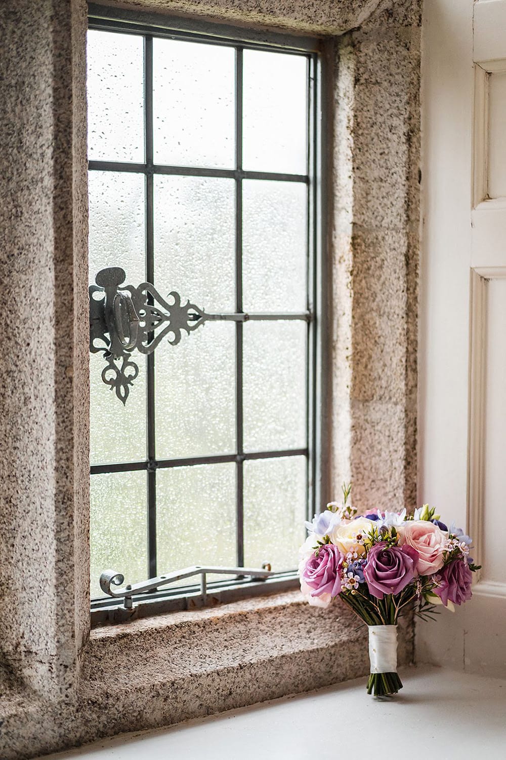 Castle elopement wedding bouquet besid the castel window 