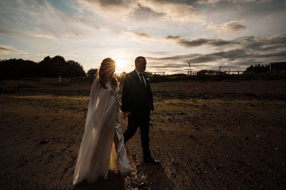 castle elopement bride and groom walking in the twilight 