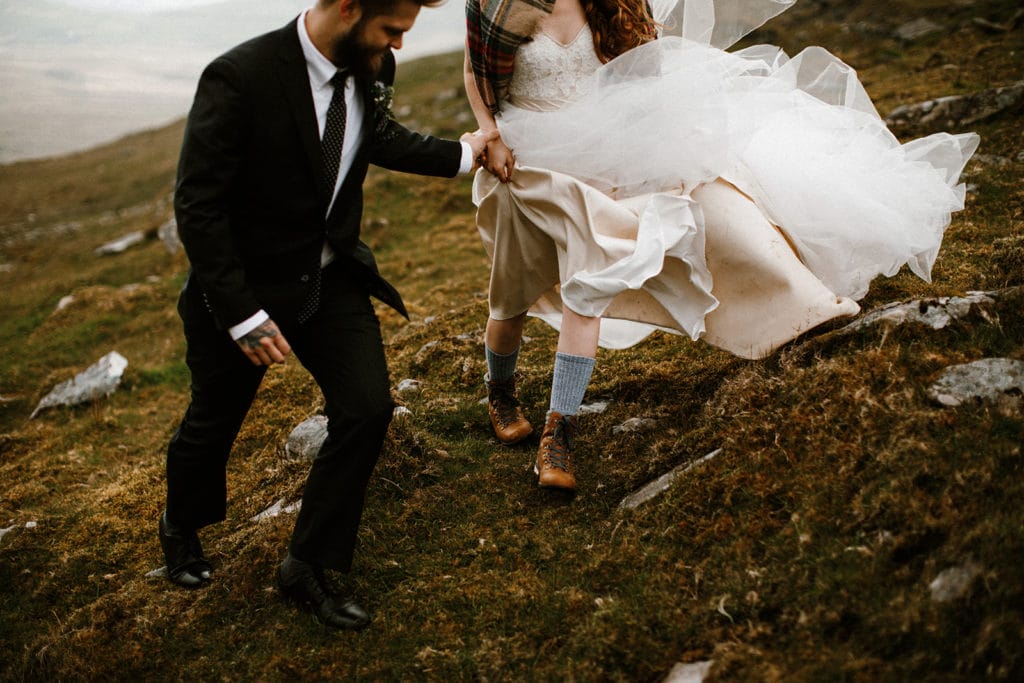the wedding couple going up a mountain at their Wedding in Ireland 