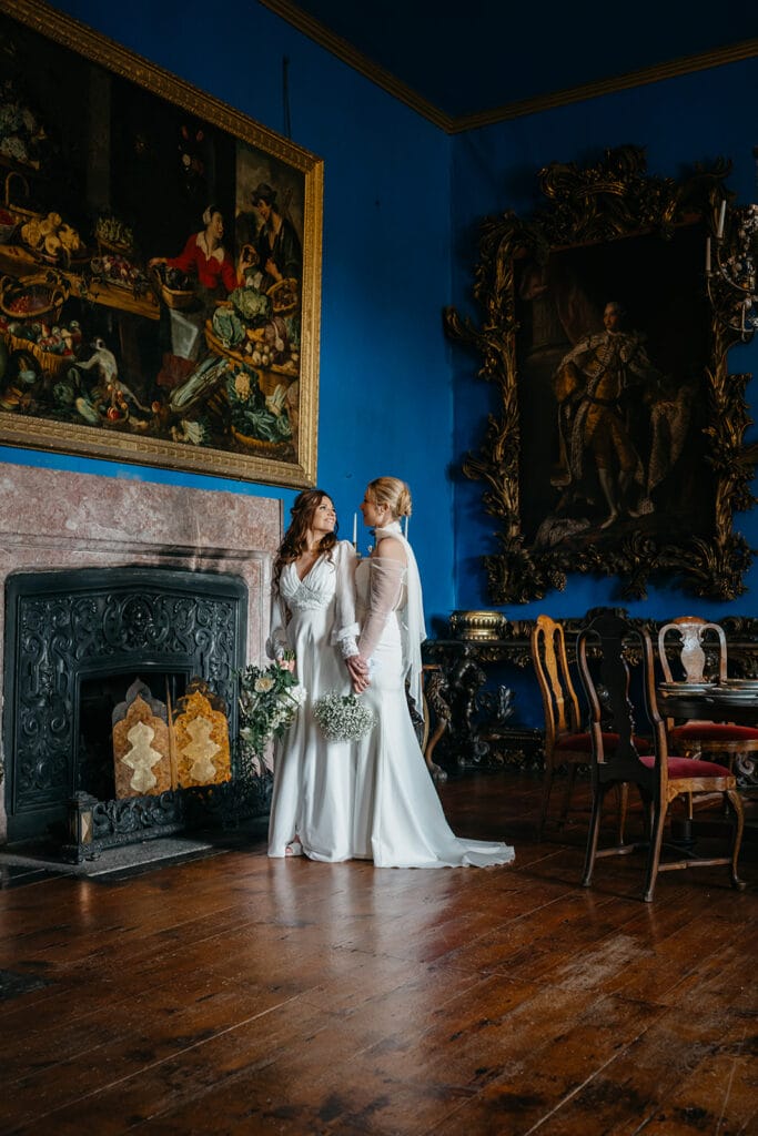 beautiful west Cork wedding ceremony at Bantry House brides standing close to gether in an elegant room 